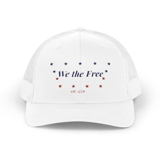 White cap with 'We the Free' text and stars on a white background