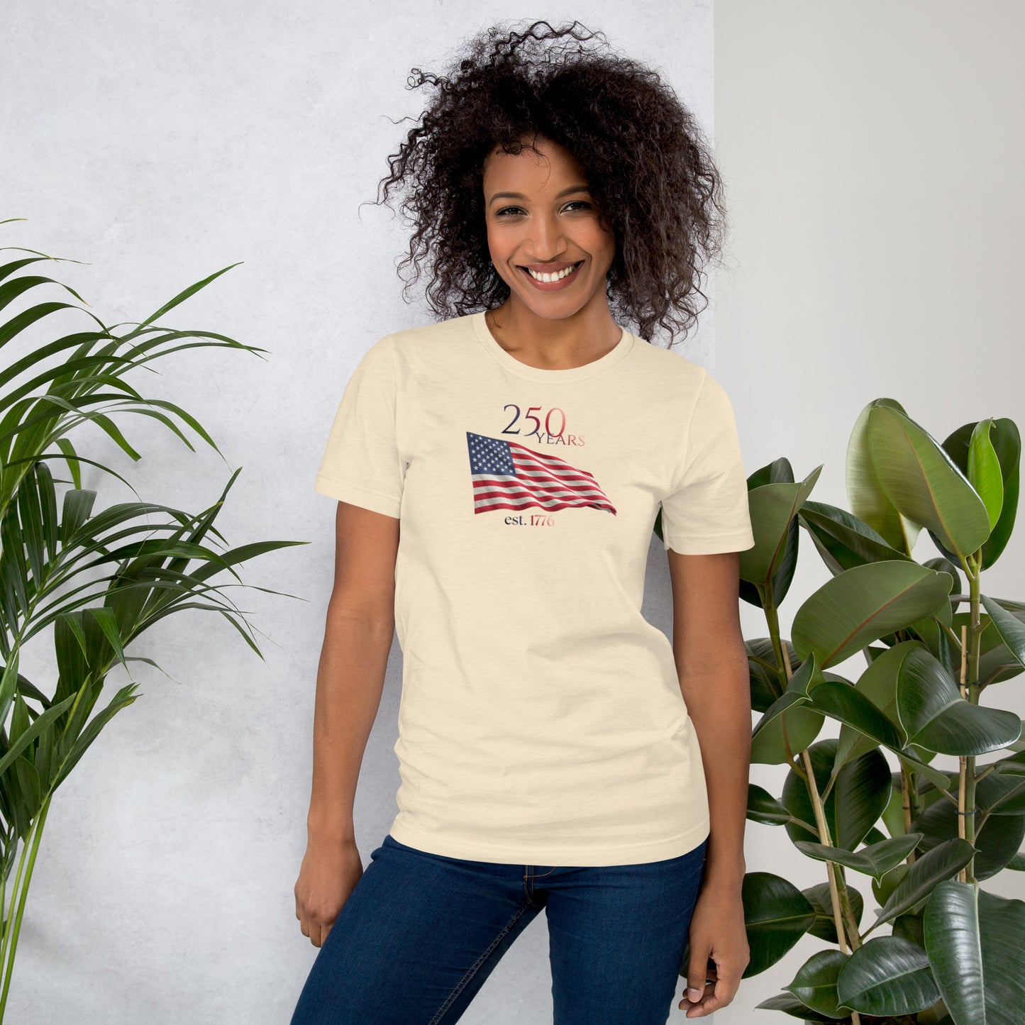 Woman wearing America 250th anniversary heather natural t-shirt American flag graphic Est 1776 unisex fit Bella Canvas