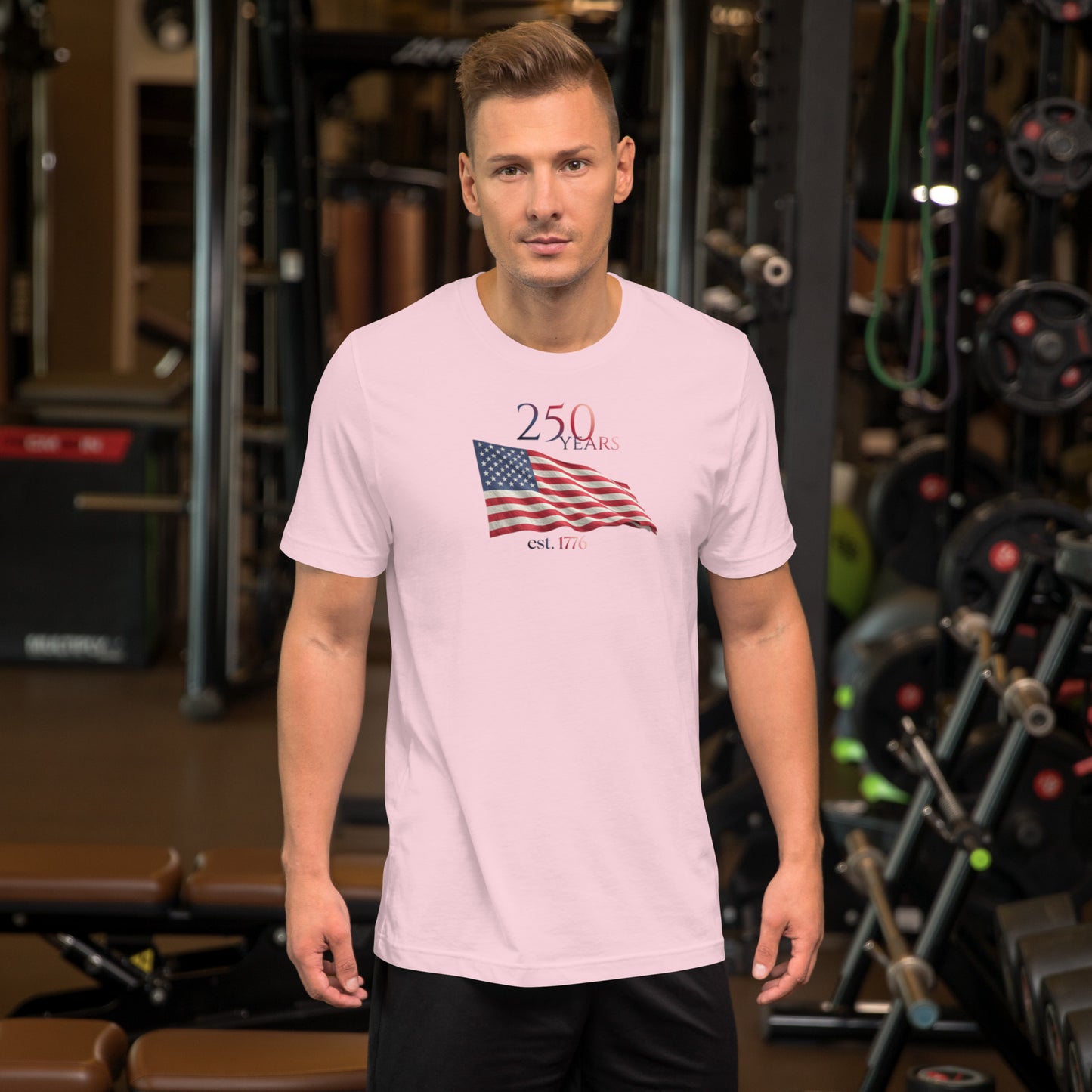 Man wearing America 250th anniversary pink t-shirt American flag graphic Est 1776 unisex fit Bella Canvas