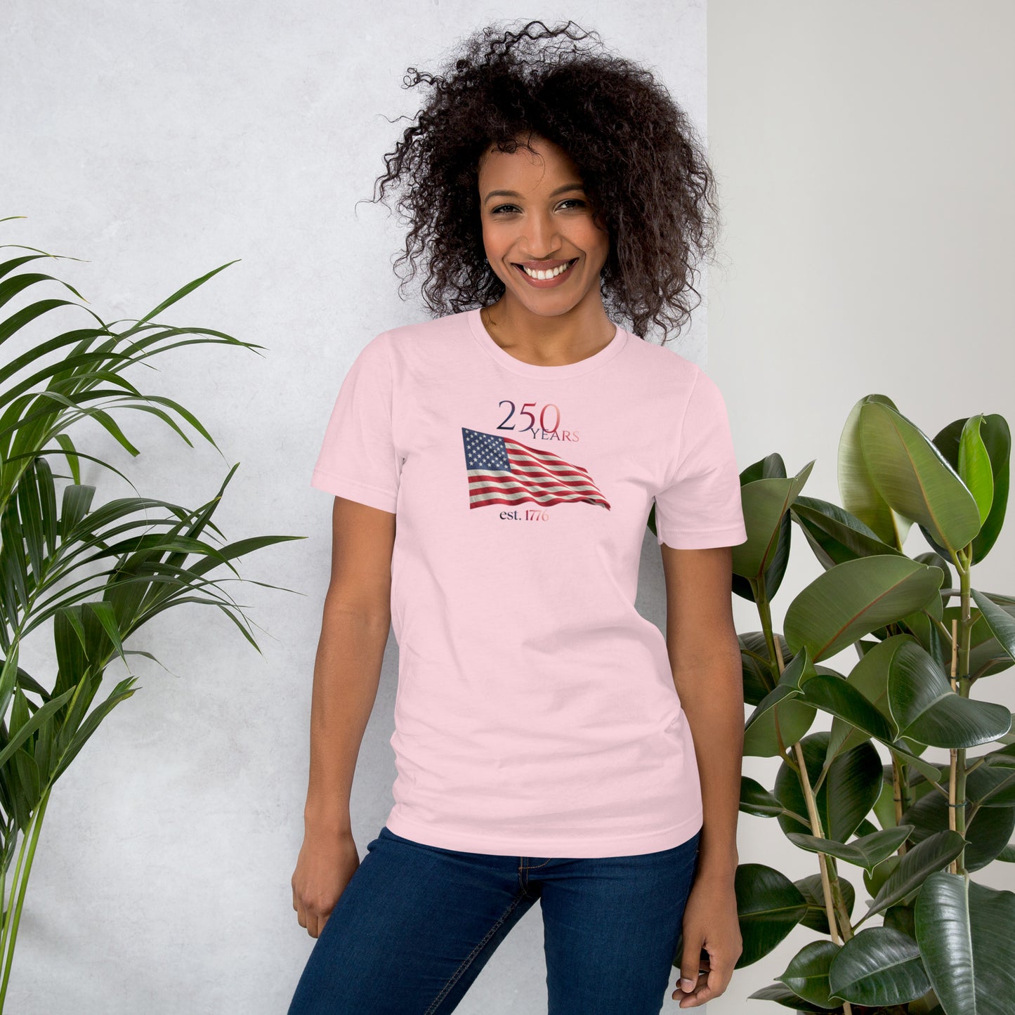 Woman wearing America 250th anniversary pink t-shirt American flag graphic Est 1776 unisex fit Bella Canvas
