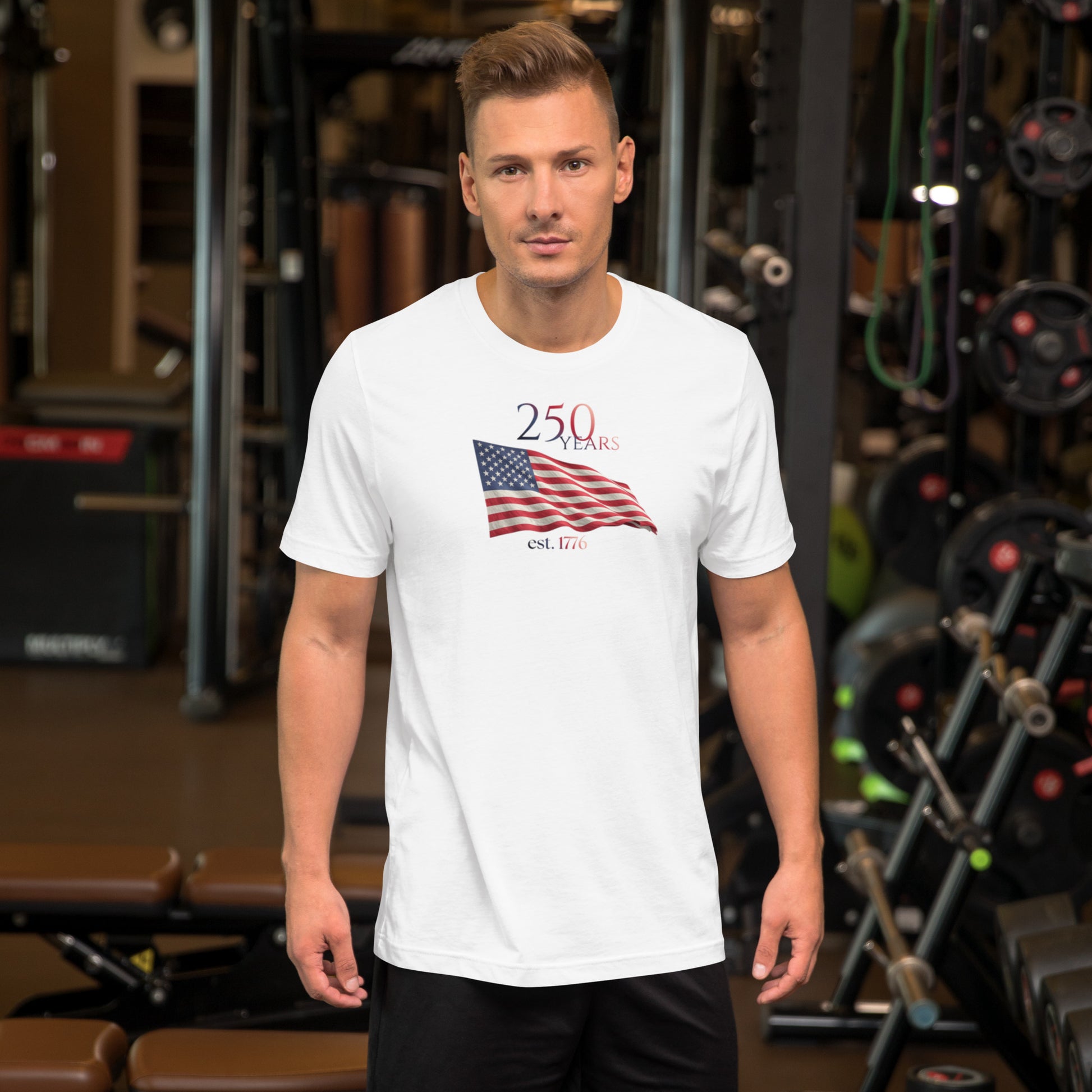 Man wearing America 250th anniversary white t-shirt American flag graphic Est 1776 unisex fit Bella Canvas